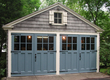 Custom made swing out carriage doors enhance the character of this carriage house