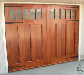 Carriage doors with flat panels and reeded glass have a contemporary but classic look.