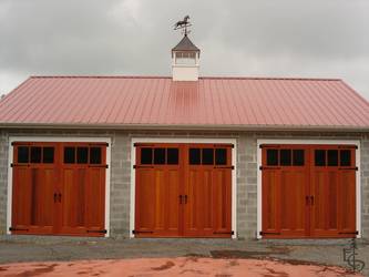Carriage doors and a weather vane create a new classic carriage house.