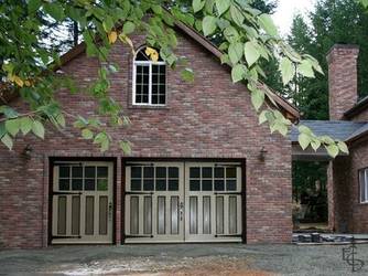 Brick carriage house with a custom 3-door set of OL8L doors with 4 panels.