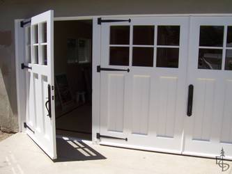3 carriage doors enclose a newly remodeled studio exercise room turning an unused garage into new living space.