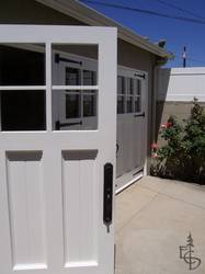 close up view of a 3 door set of Olympic style carriage garage doors